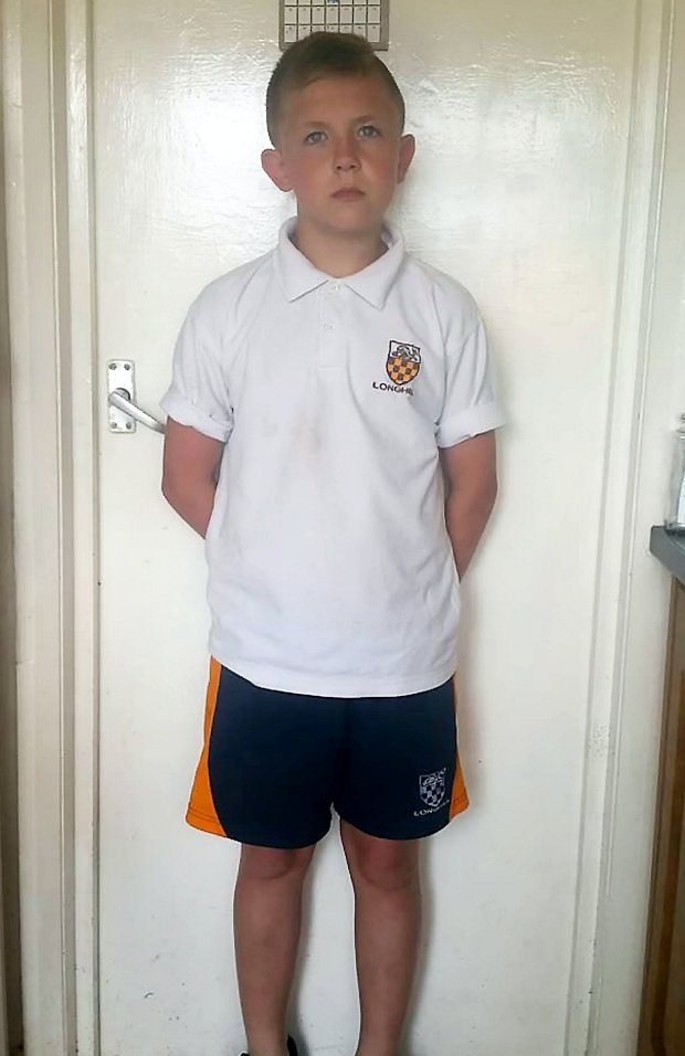 Michael Parker (14) of Longhill Hill High School Brighton, wearing his shorts. Four teenage boys who were excluded for wearing shorts to school on the hottest day of the year have got around the stringent rules - by wearing SKIRTS. See NATIONAL story NNSKIRT. The Year 9 children put on their PE shorts on Tuesday, as they had done last summer, when temperatures hit 33C in a bid to cool down in the sweltering heat. But in a change of policy, Longhill High School in Brighton, East Sussex, ordered the youngsters to go home and put on trousers and sent them in isolation. Michael Parker, Kodi Ailing, George Boyland and Jesse Stringer, all 14, then decided to protest and wear skirts to school after finding a loophole in the code of conduct.